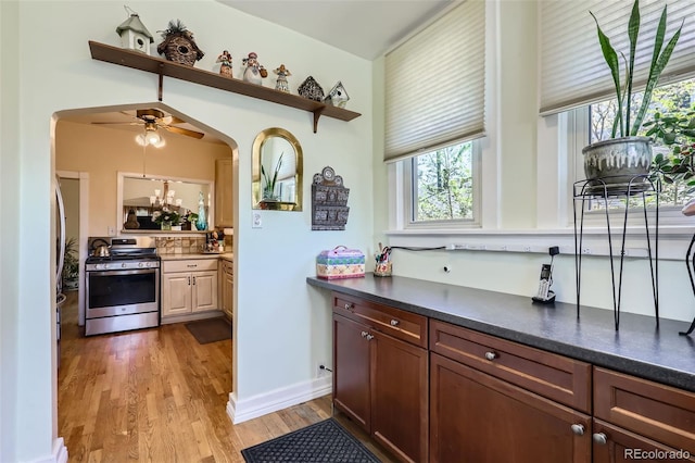 1559 Elm St, Denver, CO 80220 - kitchen with gas range, light wood-type flooring, dark countertops, a ceiling fan, and open shelves