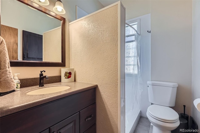 1559 Elm St, Denver, CO 80220 - bathroom with vanity, toilet, a shower with shower curtain, a textured wall, and tile patterned flooring