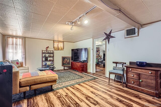 1559 Elm St, Denver, CO 80220 - living room with rail lighting and wood finished floors