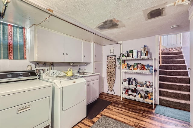 1559 Elm St, Denver, CO 80220 - laundry room featuring cabinet space, washer and dryer, a textured ceiling, and light wood-style flooring