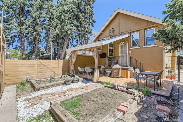 1559 Elm St, Denver, CO 80220 - back of property with a fenced backyard, a deck, a vegetable garden, and outdoor dining space