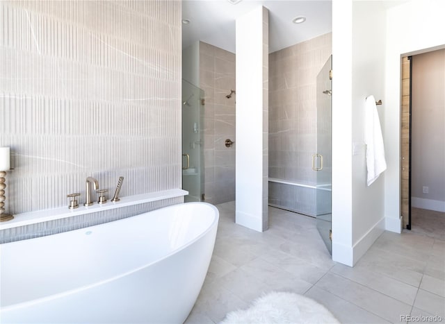 bathroom featuring tile patterned flooring, shower with separate bathtub, and tile walls