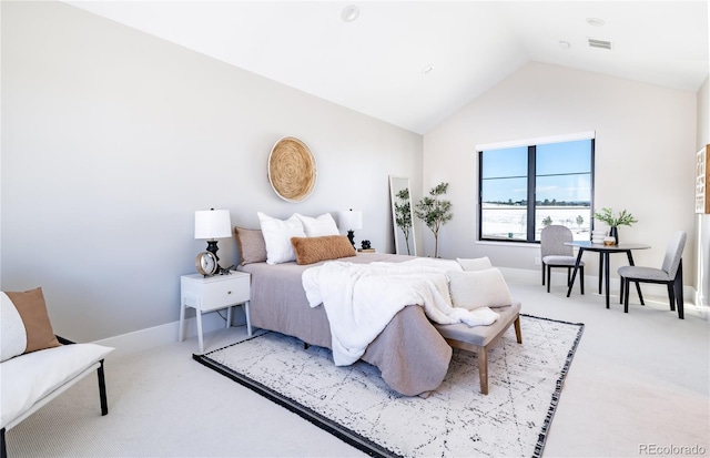 carpeted bedroom with lofted ceiling