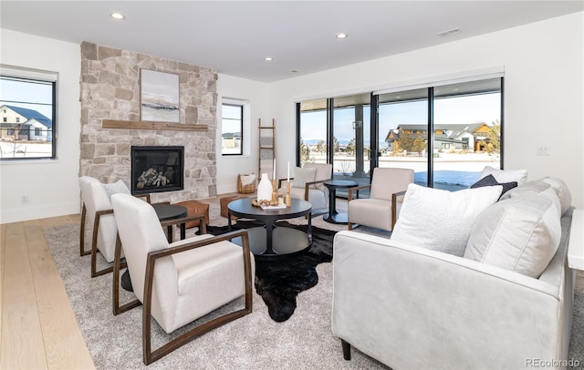 living room with light hardwood / wood-style floors and a fireplace