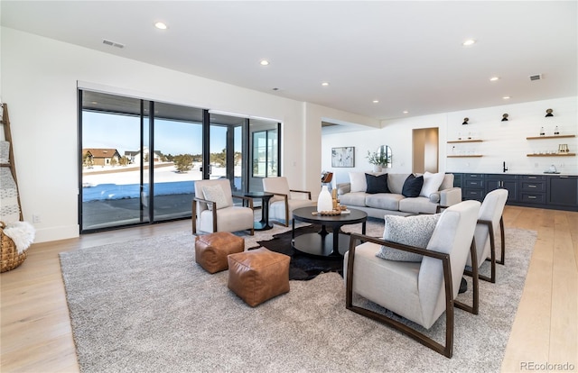 living room featuring light hardwood / wood-style flooring and indoor bar