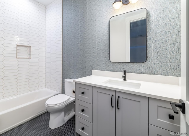 full bathroom with toilet, vanity, and tiled shower / bath