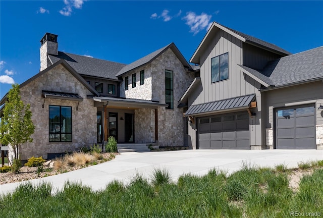 2442 Fox View Trl, Franktown, CO 80116 - view of front of home with a standing seam roof, a chimney, board and batten siding, concrete driveway, and stone siding