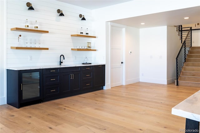 2442 Fox View Trl, Franktown, CO 80116 - indoor wet bar featuring light wood-style floors, stairway, baseboards, recessed lighting, and beverage cooler