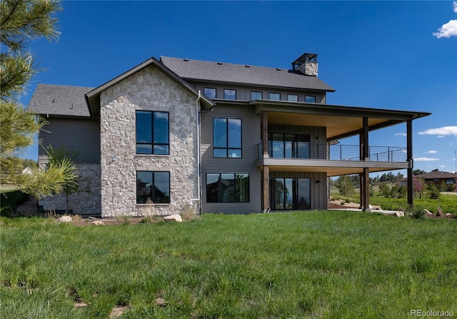 2442 Fox View Trl, Franktown, CO 80116 - back of property with a balcony, stone siding, a chimney, and a yard