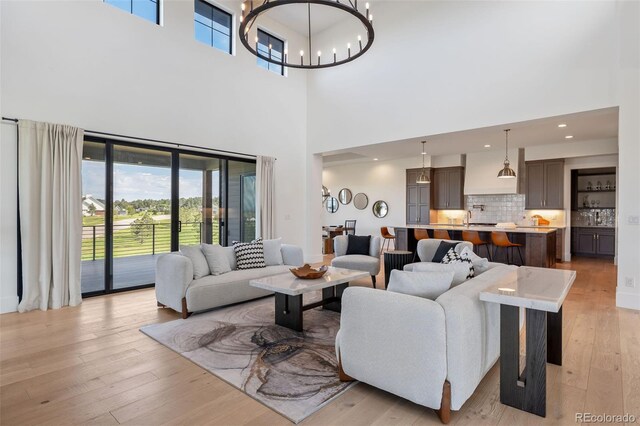 2442 Fox View Trl, Franktown, CO 80116 - living area featuring a high ceiling, a chandelier, light wood-style flooring, and recessed lighting