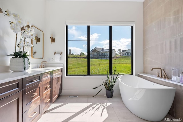 2442 Fox View Trl, Franktown, CO 80116 - full bathroom featuring vanity, a freestanding tub, and tile patterned flooring