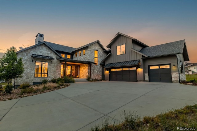 2442 Fox View Trl, Franktown, CO 80116 - view of front of home with stone siding, a standing seam roof, board and batten siding, driveway, and a metal roof