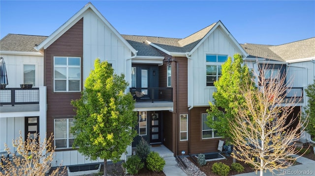 10165 E 59th Ave, Denver, CO 80238 - townhome / multi-family property featuring a balcony, roof with shingles, and board and batten siding