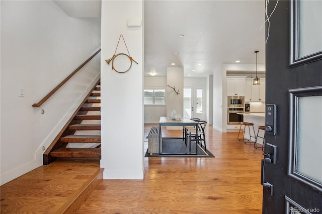 10165 E 59th Ave, Denver, CO 80238 - foyer entrance featuring recessed lighting, light wood-style flooring, baseboards, and stairs