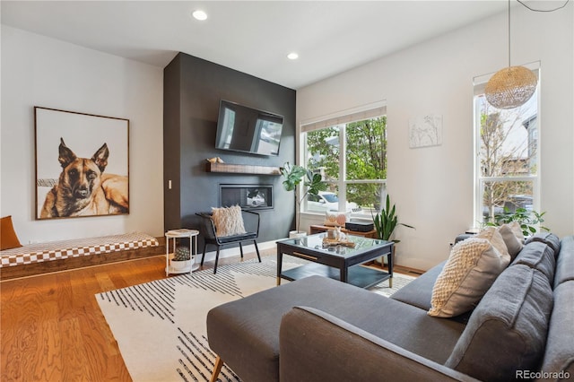 10165 E 59th Ave, Denver, CO 80238 - living area featuring a glass covered fireplace, recessed lighting, and wood finished floors