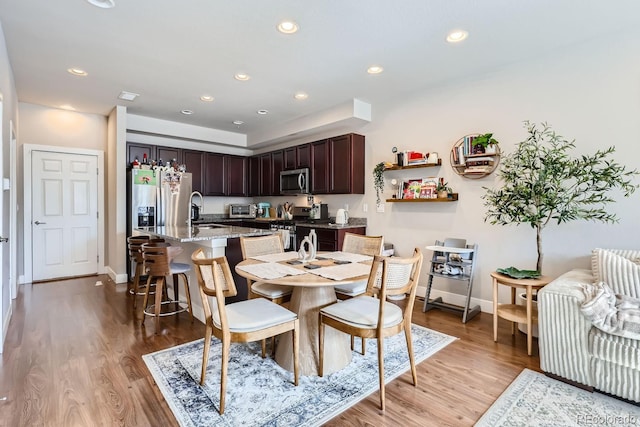 dining area featuring wood-type flooring and sink