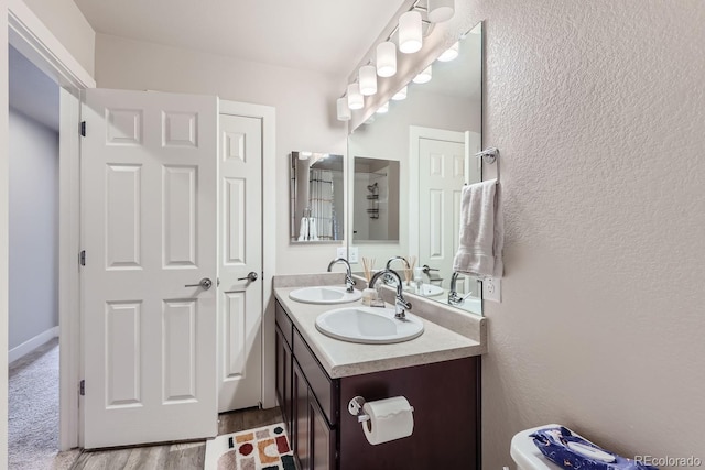 bathroom with hardwood / wood-style floors and vanity