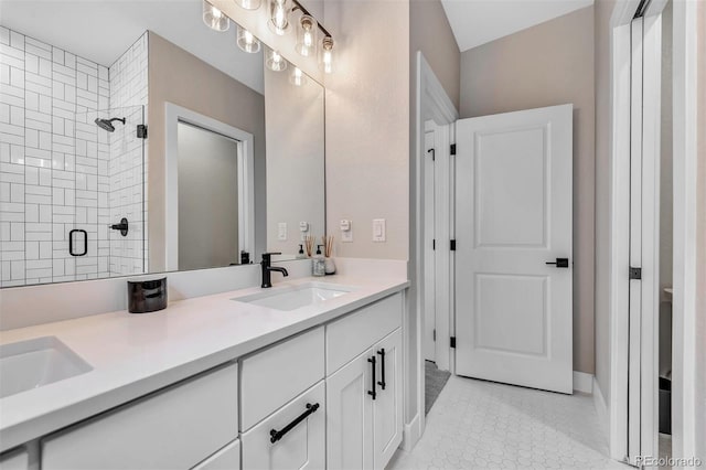 bathroom with double vanity, a stall shower, and a sink