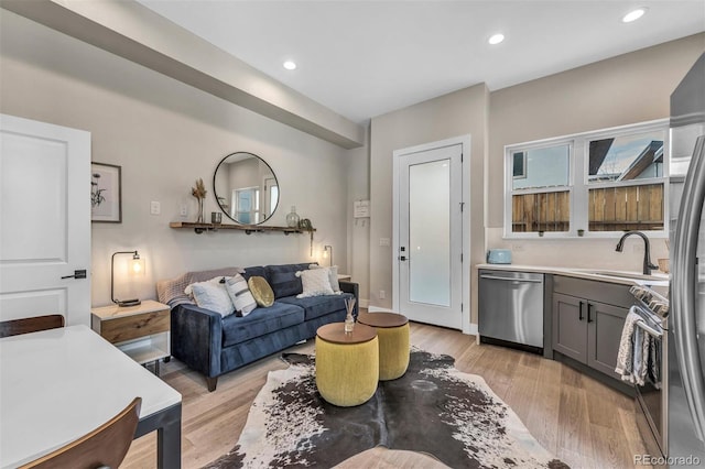 living area featuring light wood-style floors and recessed lighting