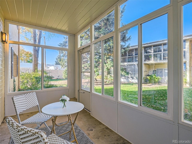 sunroom with vaulted ceiling and a wealth of natural light