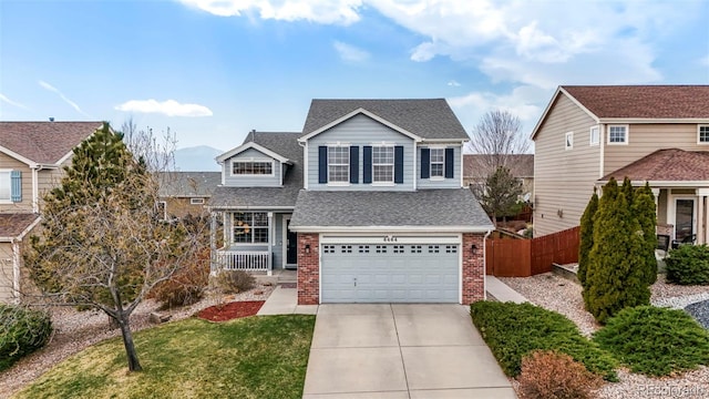 6464 Elsinore Dr, Colorado Springs, CO 80923 - traditional home with roof with shingles, fence, brick siding, an attached garage, and driveway