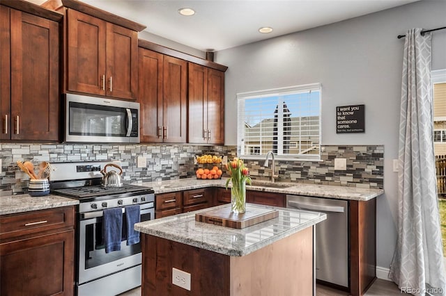 6464 Elsinore Dr, Colorado Springs, CO 80923 - kitchen with tasteful backsplash, recessed lighting, light stone countertops, appliances with stainless steel finishes, and a sink