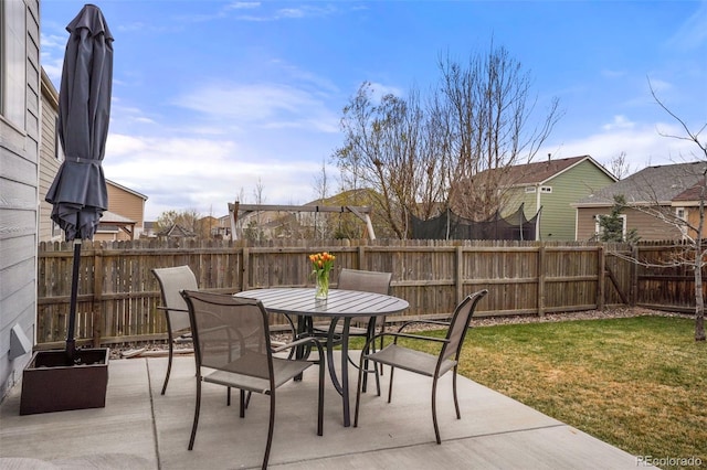 6464 Elsinore Dr, Colorado Springs, CO 80923 - view of patio featuring outdoor dining space, a fenced backyard, and a residential view