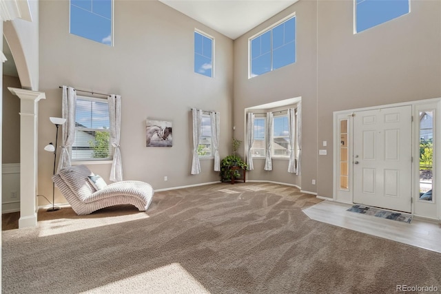 42311 Forest Oaks Dr, Elizabeth, CO 80107 - carpeted entrance foyer featuring a high ceiling, arched walkways, healthy amount of natural light, and baseboards