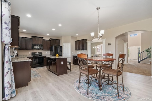 42311 Forest Oaks Dr, Elizabeth, CO 80107 - dining room with decorative columns, arched walkways, light wood-style flooring, a chandelier, and recessed lighting