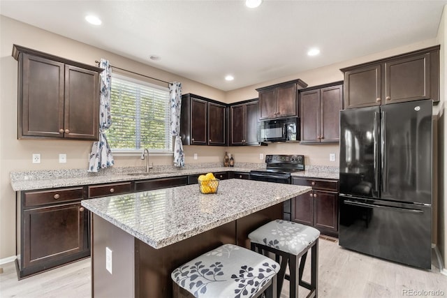 42311 Forest Oaks Dr, Elizabeth, CO 80107 - kitchen featuring black appliances, a sink, light wood-style floors, dark brown cabinets, and recessed lighting