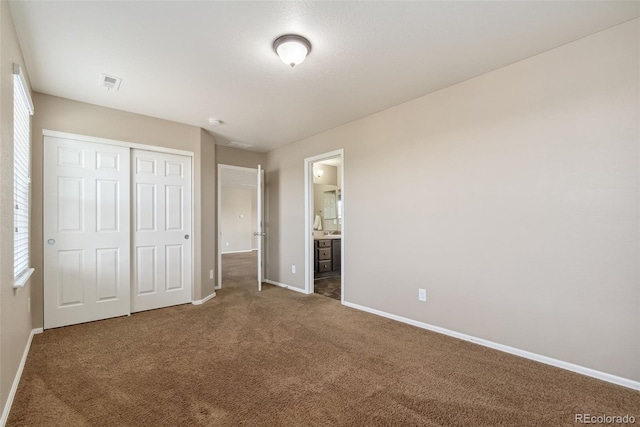 42311 Forest Oaks Dr, Elizabeth, CO 80107 - unfurnished bedroom featuring baseboards, carpet floors, multiple windows, and a closet