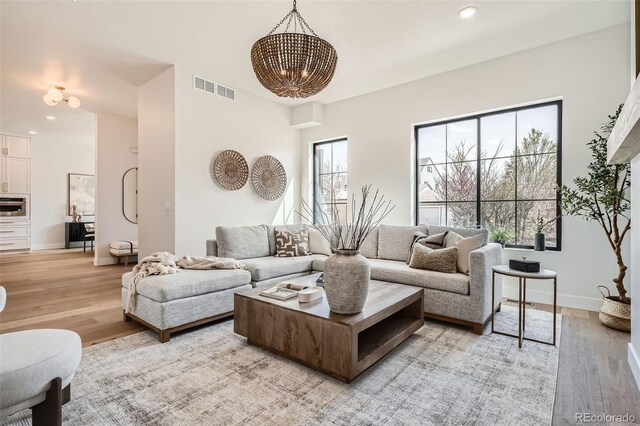 3649 W 21st Ave, Denver, CO 80211 - living area featuring a chandelier, light wood-style floors, baseboards, and recessed lighting