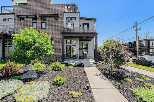 4102 Quivas St, Denver, CO 80211 - modern home featuring a balcony, brick siding, and a porch