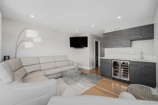 4102 Quivas St, Denver, CO 80211 - living room featuring wine cooler, bar with sink, dark wood-style flooring, and recessed lighting