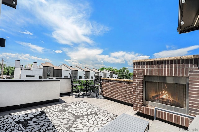 4102 Quivas St, Denver, CO 80211 - deck featuring an outdoor brick fireplace, outdoor dining space, and a residential view