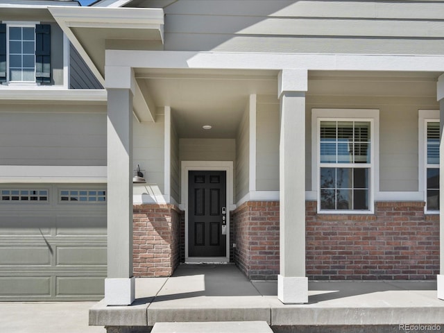 9069 Pitkin St, Commerce City, CO 80022 - doorway to property with a garage and brick siding