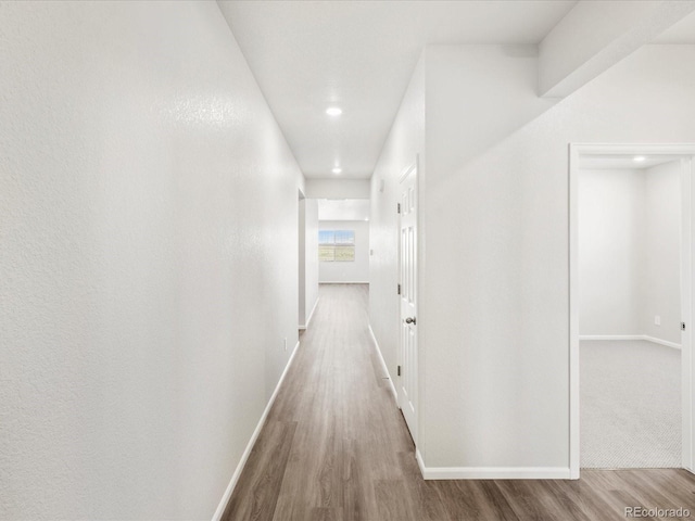 9069 Pitkin St, Commerce City, CO 80022 - hallway featuring wood finished floors, baseboards, and recessed lighting