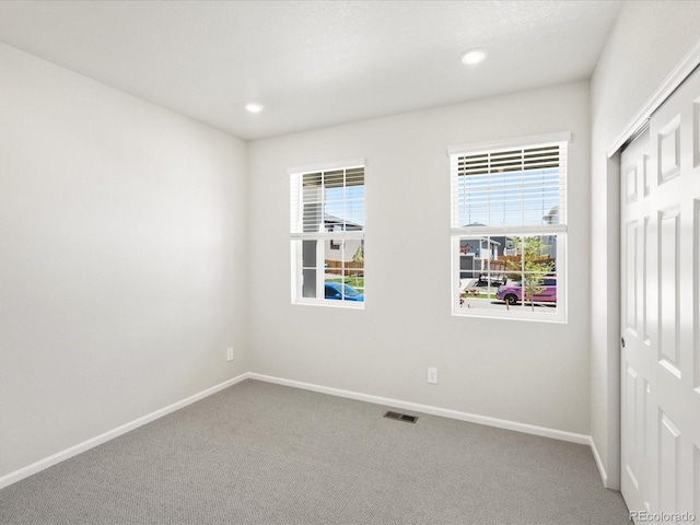 9069 Pitkin St, Commerce City, CO 80022 - unfurnished bedroom featuring a closet, carpet, baseboards, and recessed lighting