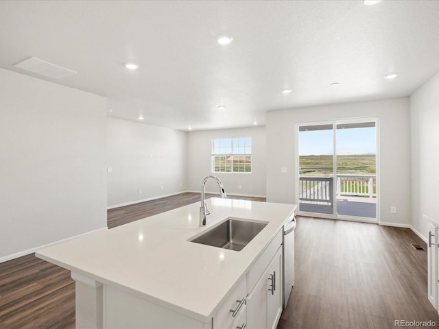 9069 Pitkin St, Commerce City, CO 80022 - kitchen with a sink, dark wood finished floors, open floor plan, white cabinets, and light countertops