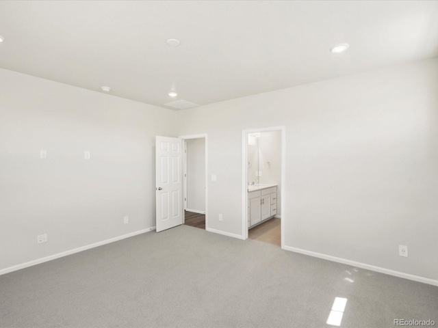 9069 Pitkin St, Commerce City, CO 80022 - unfurnished bedroom with light colored carpet, baseboards, recessed lighting, and ensuite bath