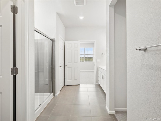 9069 Pitkin St, Commerce City, CO 80022 - bathroom featuring vanity, a shower stall, tile patterned flooring, and baseboards