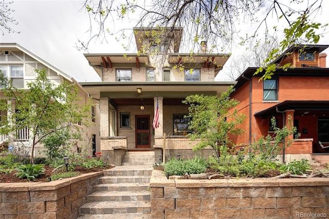 property entrance with a porch and brick siding