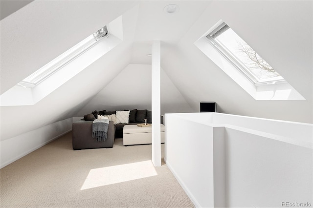 additional living space featuring carpet flooring and vaulted ceiling with skylight