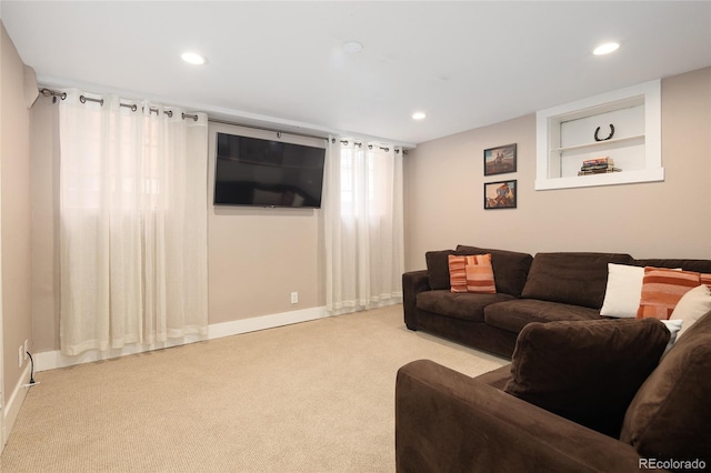 carpeted living area with recessed lighting, baseboards, and built in shelves
