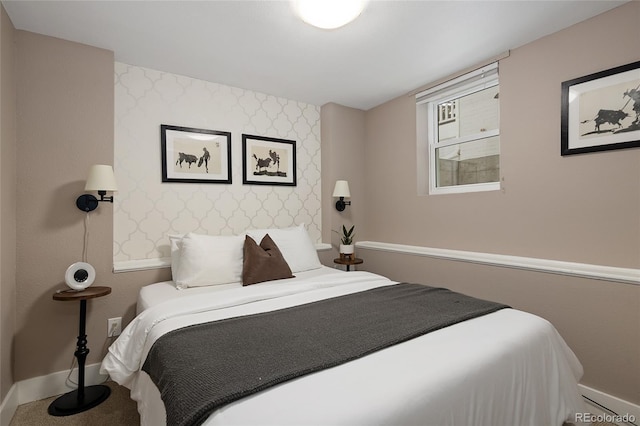 carpeted bedroom featuring baseboards, an accent wall, and wallpapered walls