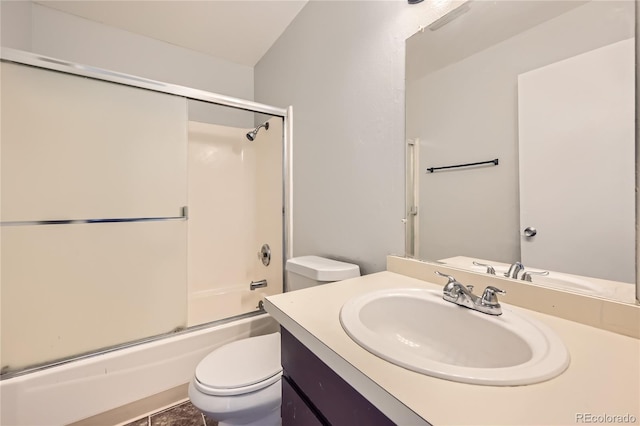 full bathroom featuring tile patterned floors, vanity, toilet, and bath / shower combo with glass door