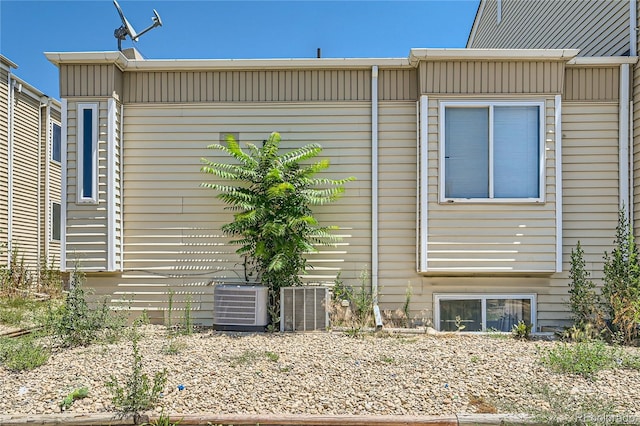 view of side of property featuring central AC