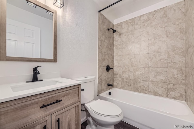 full bathroom featuring vanity, toilet, and tiled shower / bath