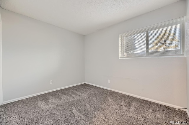 carpeted spare room featuring a textured ceiling