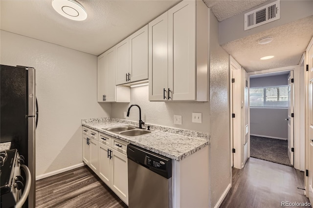 10712 E Exposition Ave Unit 209, Aurora, CO 80012 - kitchen featuring appliances with stainless steel finishes, a textured ceiling, dark wood-style floors, baseboards, and a sink